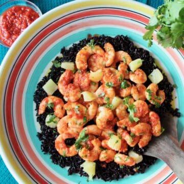 Harissa Shrimp and black rice in decorative bowl.