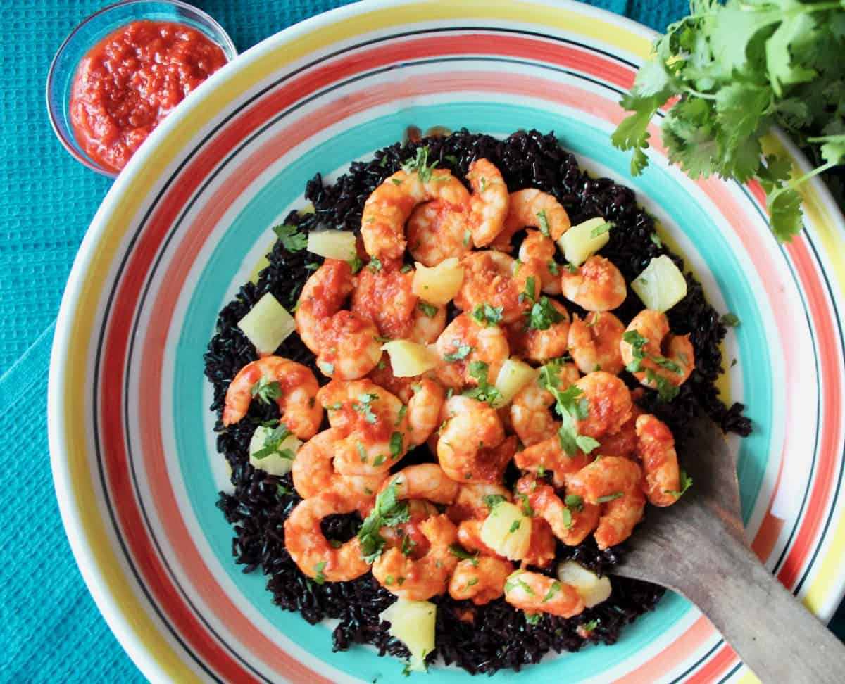 Harissa Shrimp and black rice in decorative bowl.