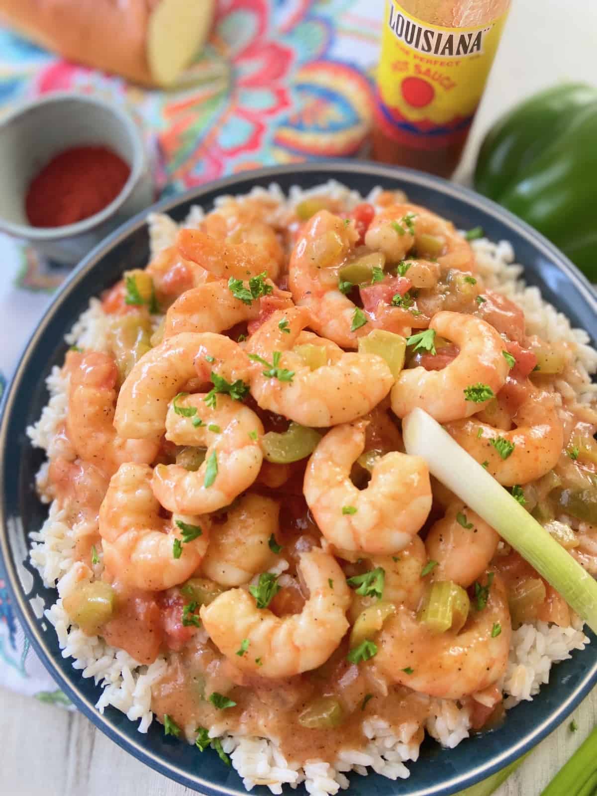 Louisiana shrimp etoufee and white rice in blue bowl.