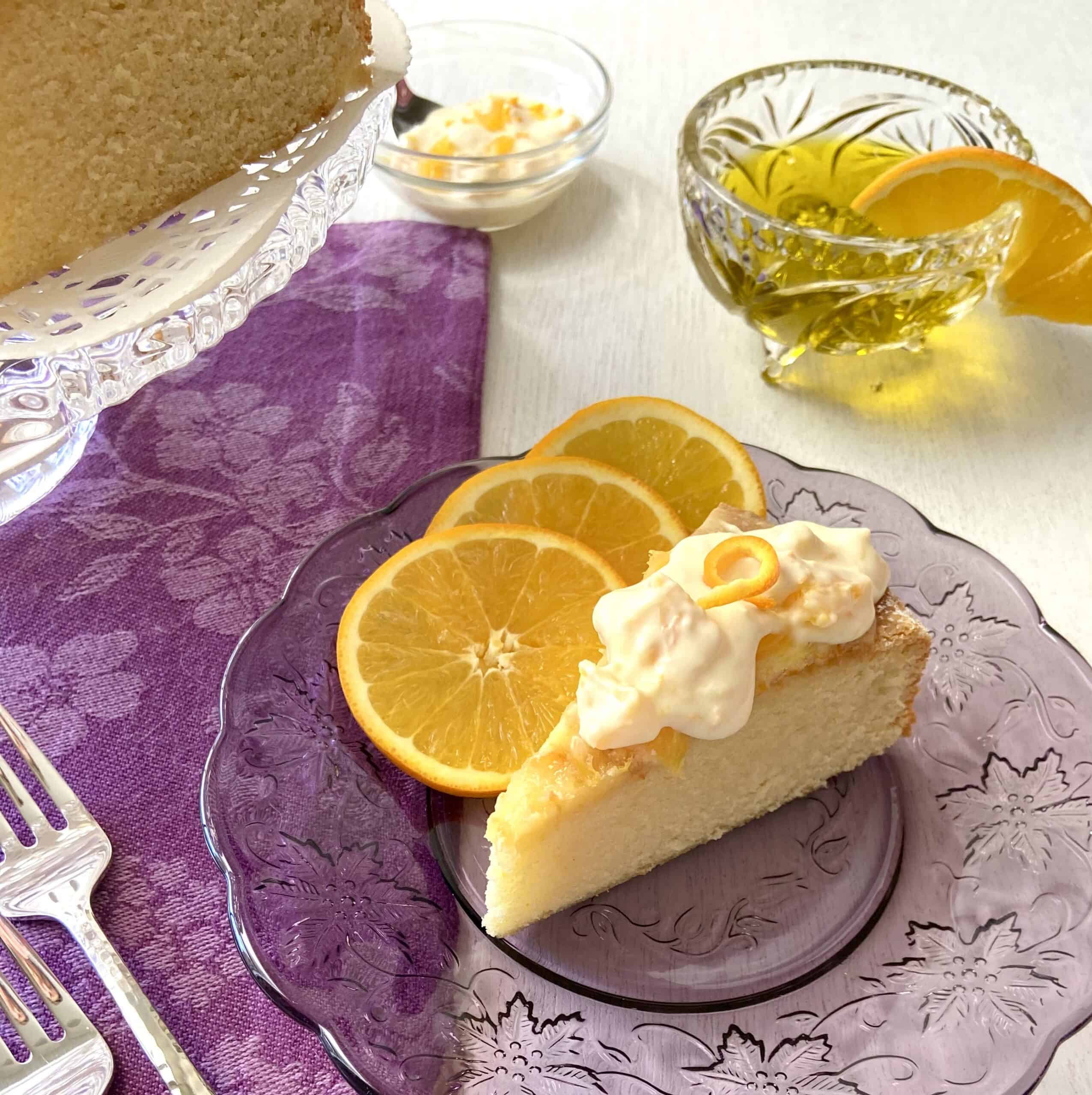 Slice of orange olive oil cake on table.