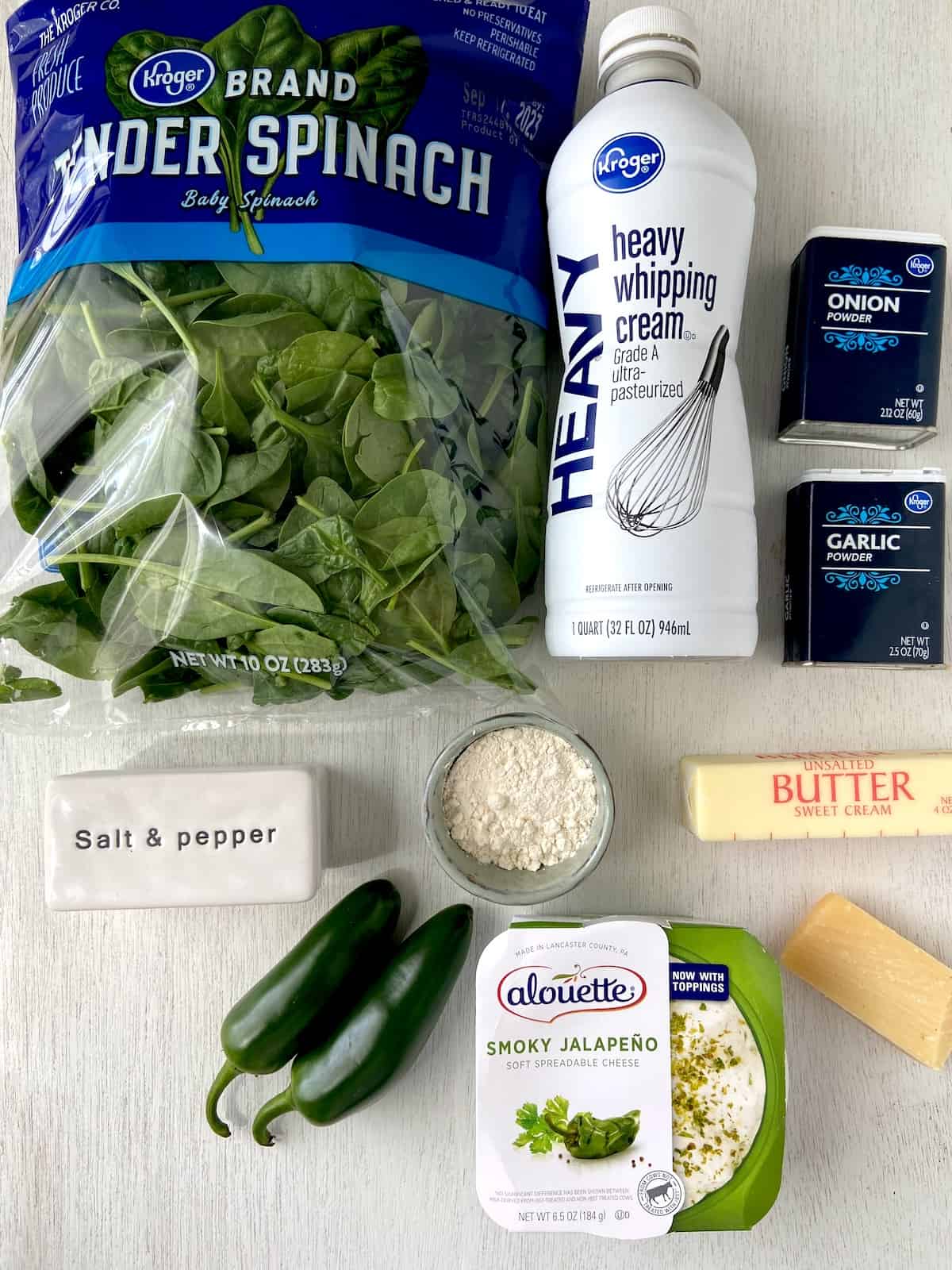 Ingredients for Tex Mex Jalapeno Creamed Spinach on white wooden board.