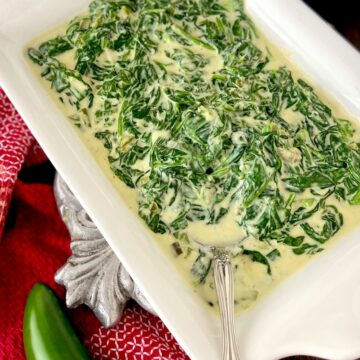 Creamed spinach in white serving bowl.