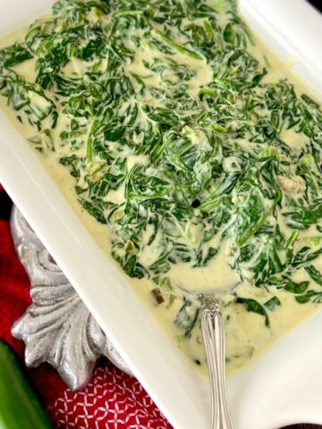 Creamed spinach in white serving bowl.