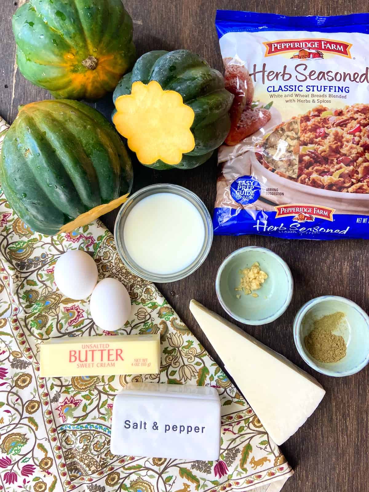 Ingredients for acorn squash casserole on brown table top.