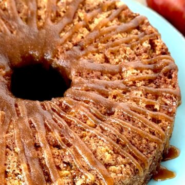 Apple cake with glaze on blue plate.