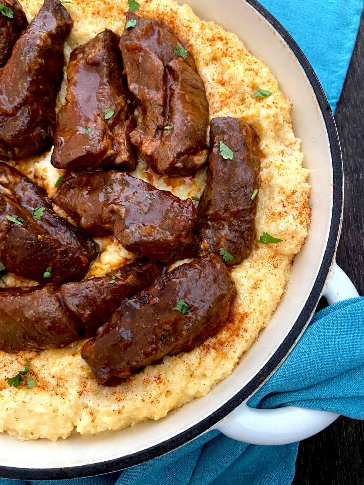 Braised short ribs on a bed of cheese grits.