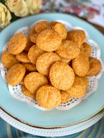 Cheddar wafers on turquoise serving platter.