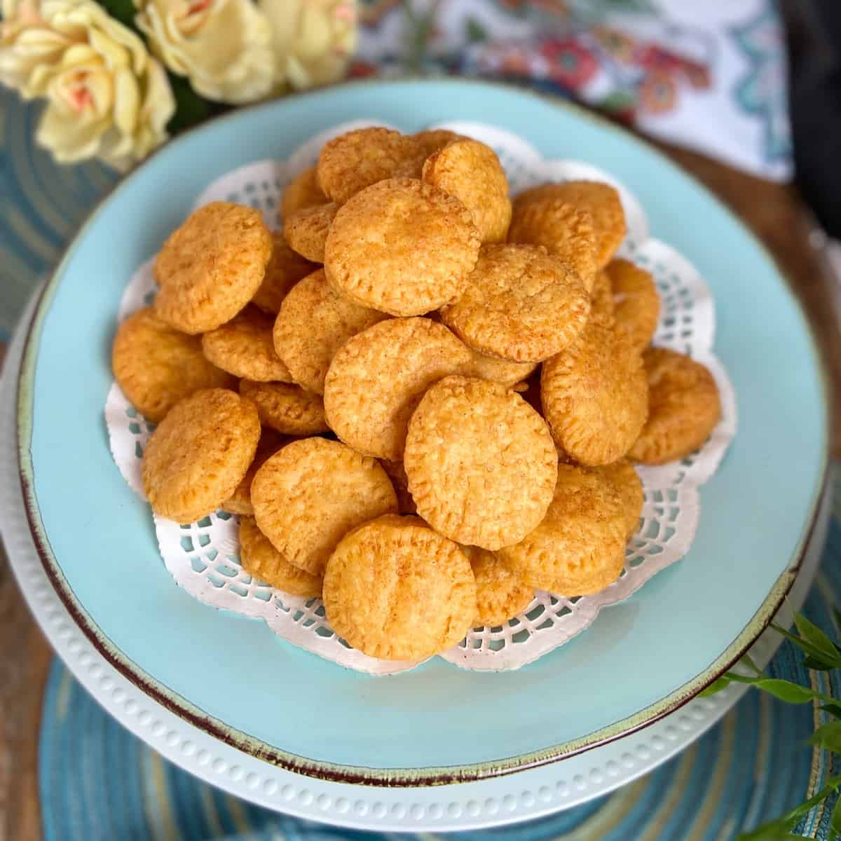 Cheddar wafers on turquoise serving platter.