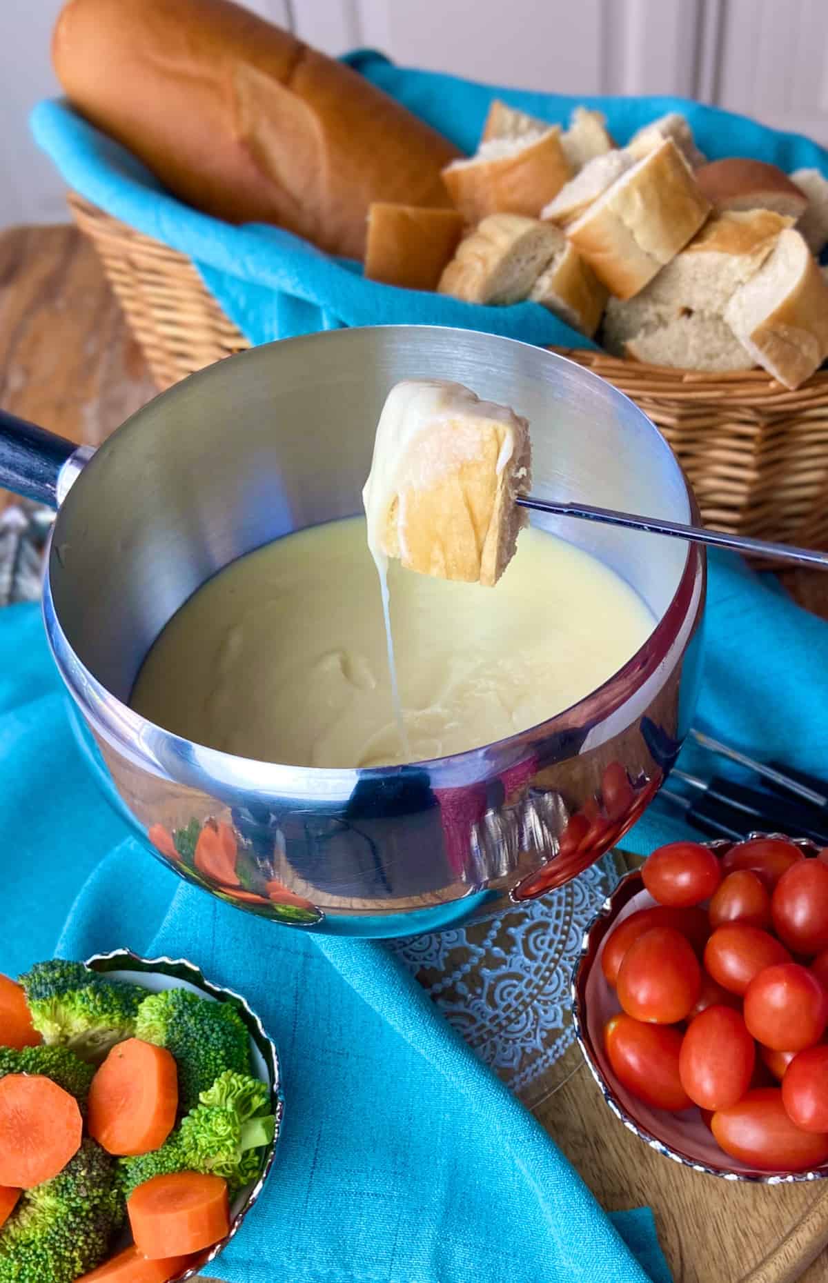 A cube of bread on a skewer dipped in classic cheese fondue.