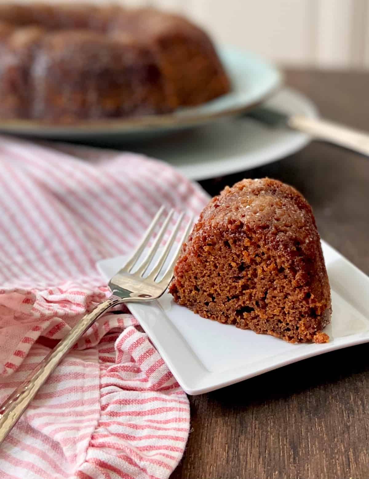 Slice of gingerbread cake on white plate.