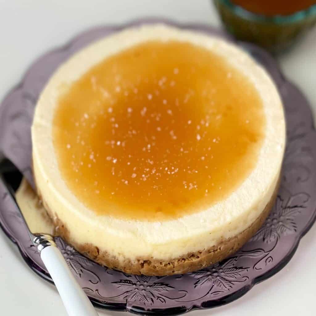 Salted caramel cheesecake on purple plate.