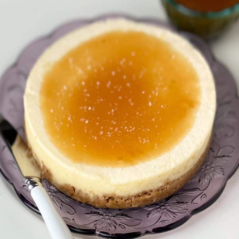 Salted caramel cheesecake on purple plate.