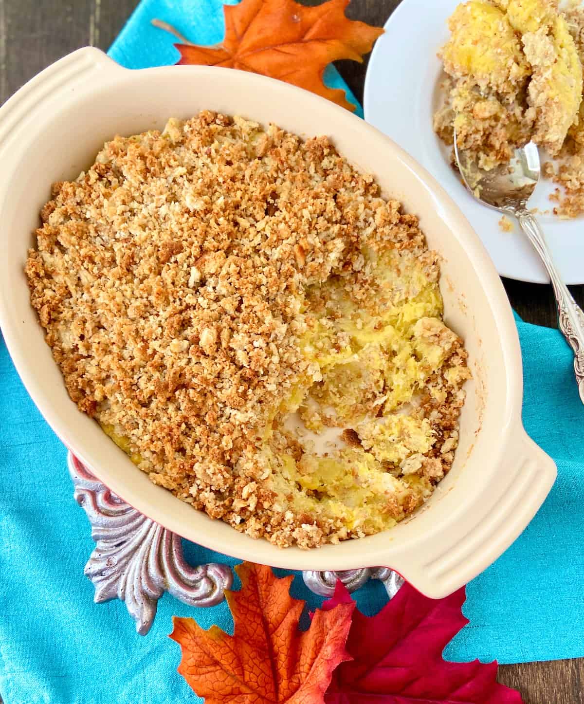 Acorn squash in serving dish topped with breadcrumbs.