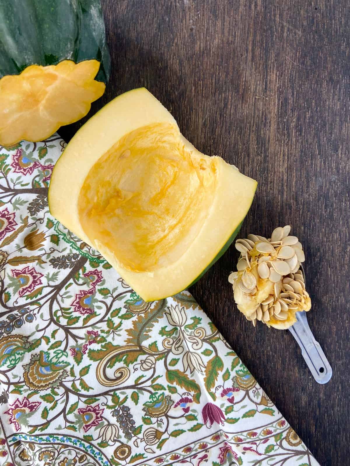 Seeds scooped out of acorn squash and in a spoon.