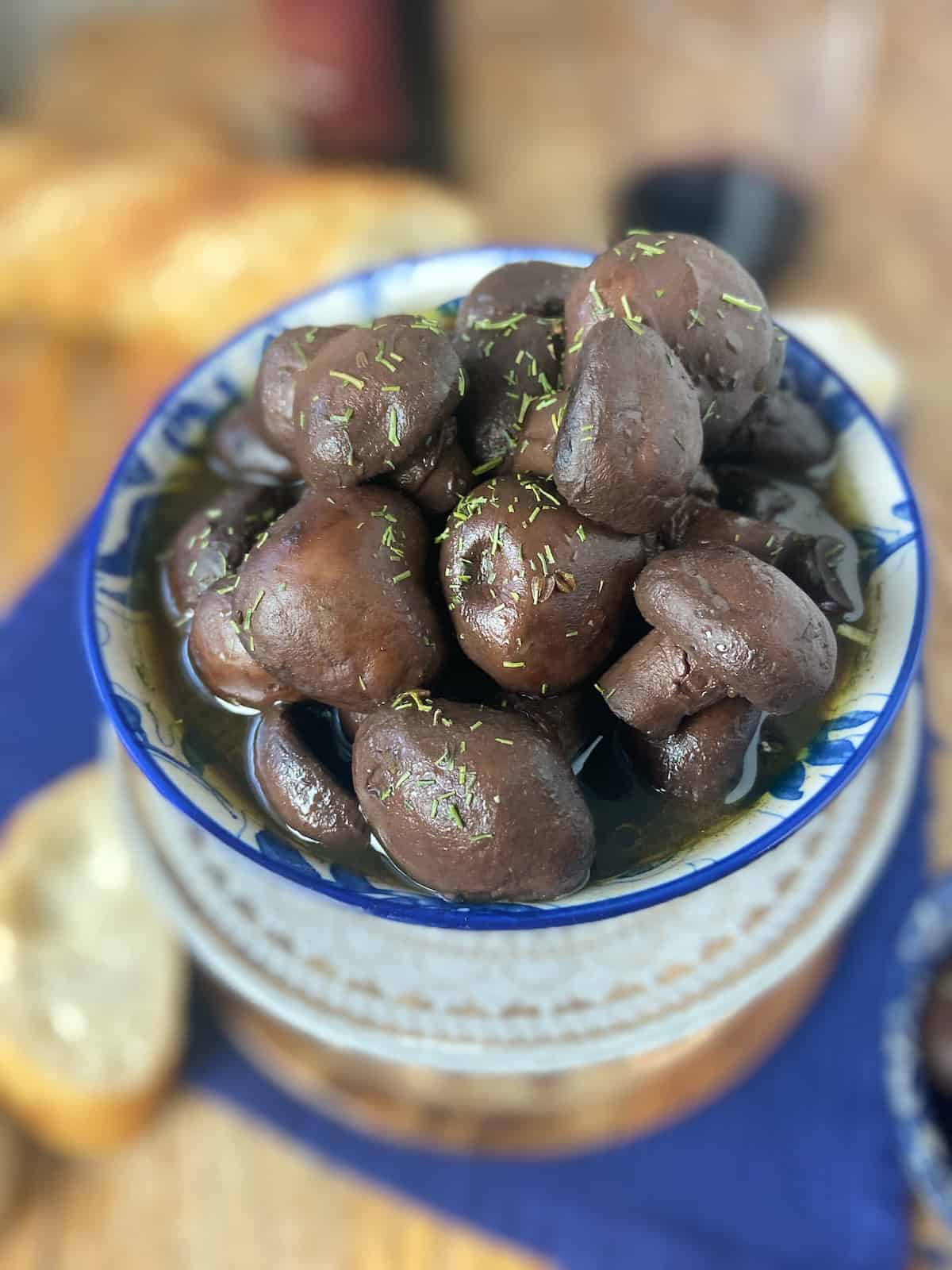 Marinated mushrooms in decorative bowl.