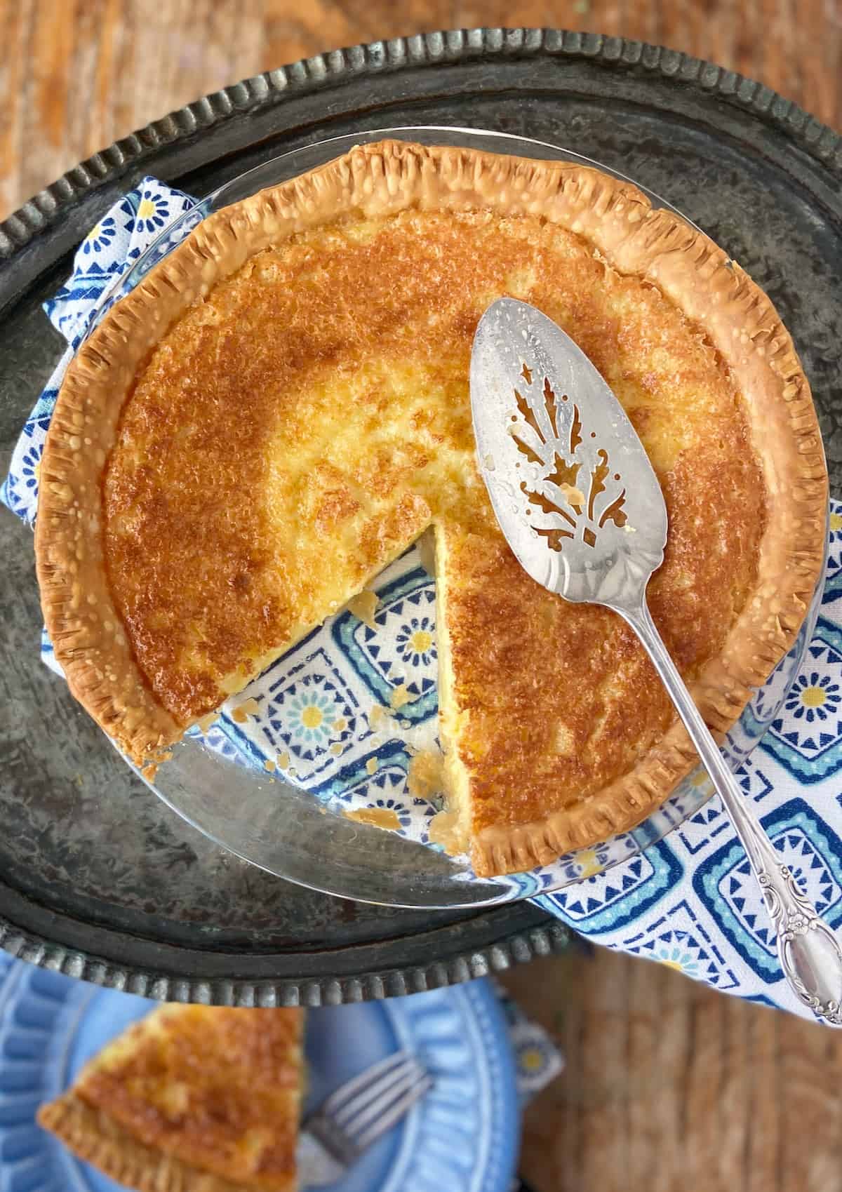 Buttermilk pie with a slice out of it.