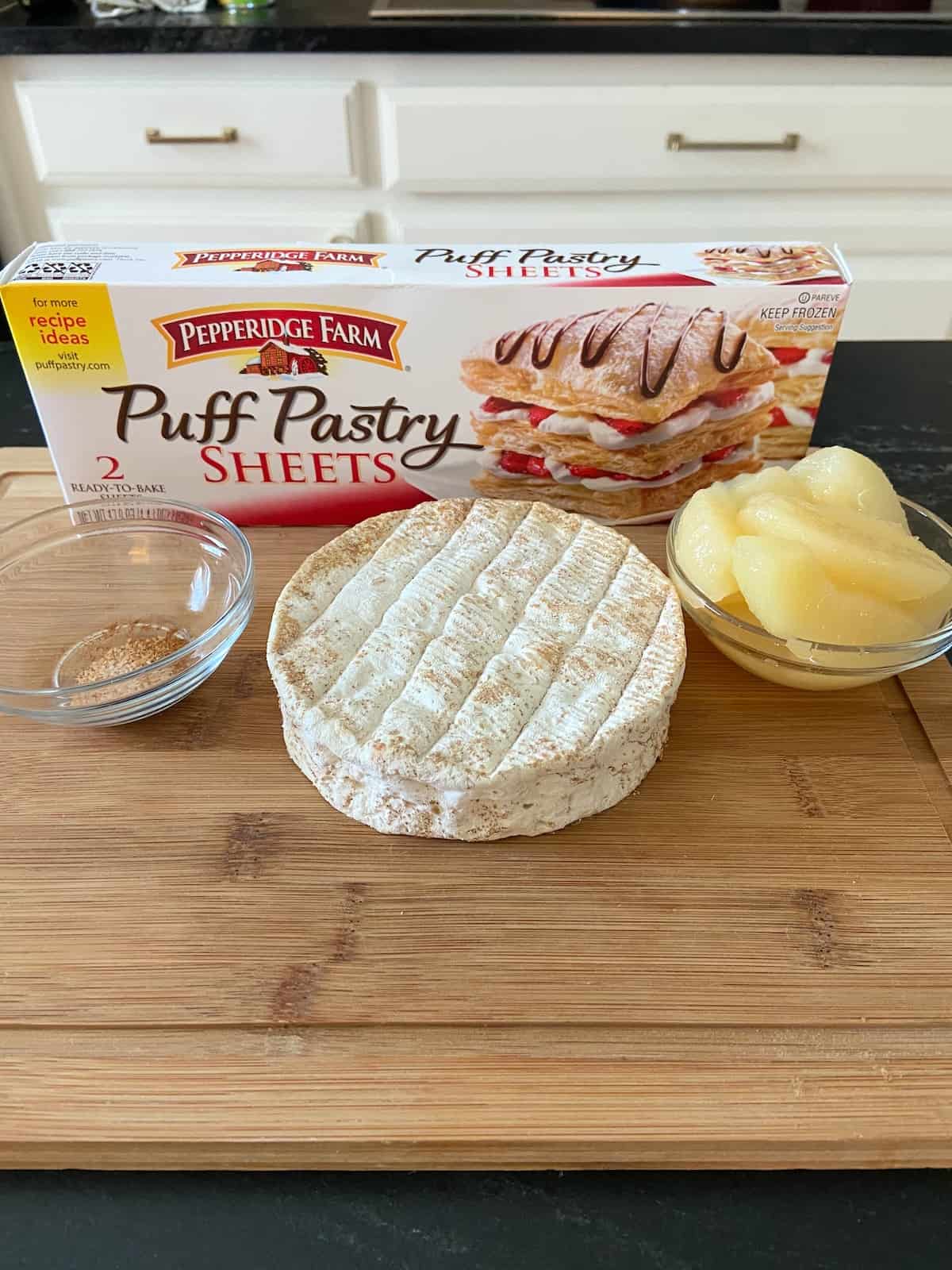 Ingredients for baked brie on cutting board.