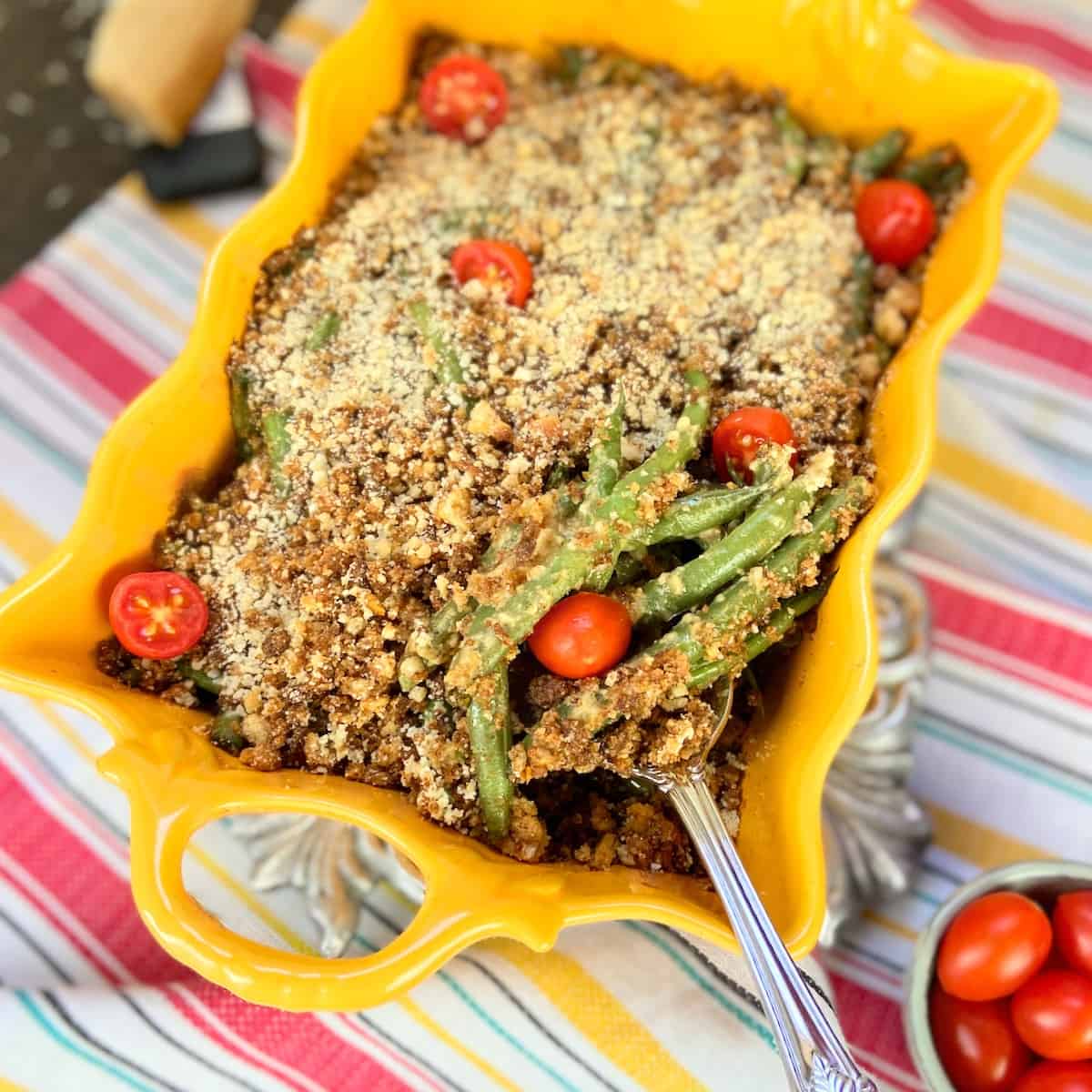 Caesar green bean casserole in scalloped gold casserole dish.