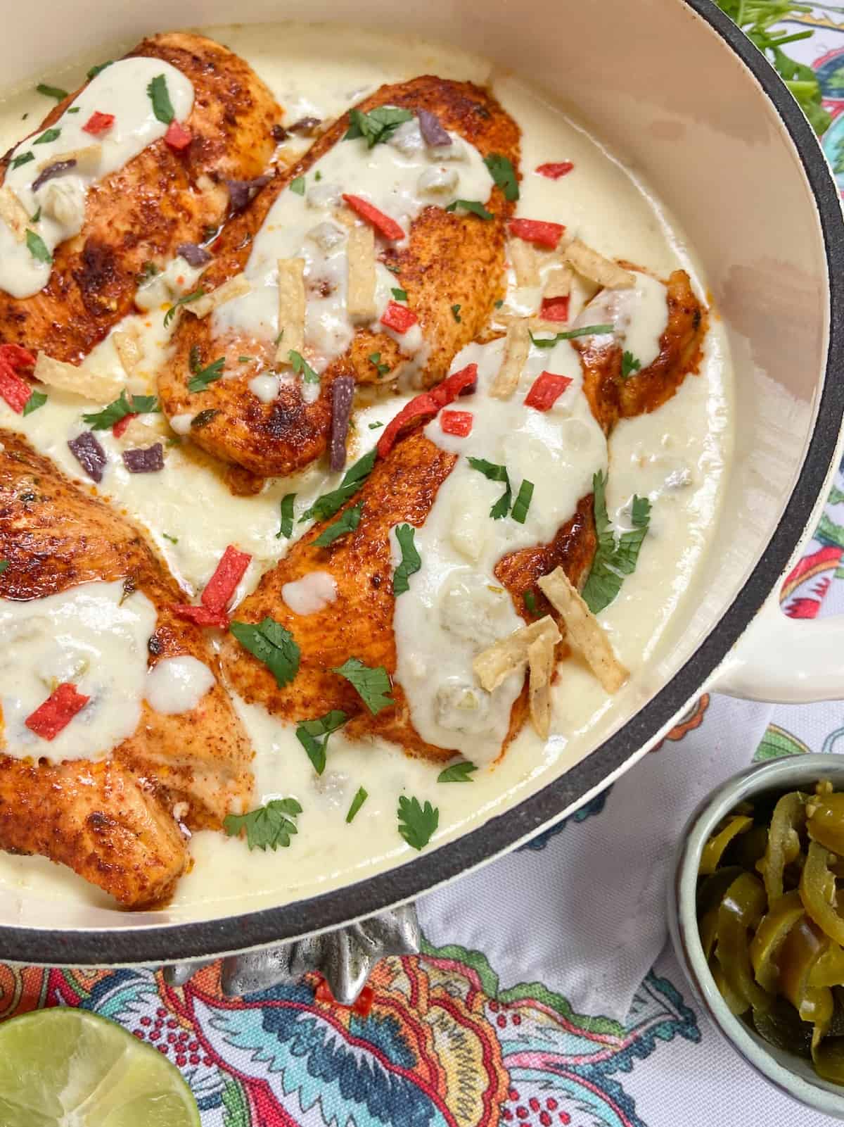 Mexican chicken with sour cream sauce in shallow pan.