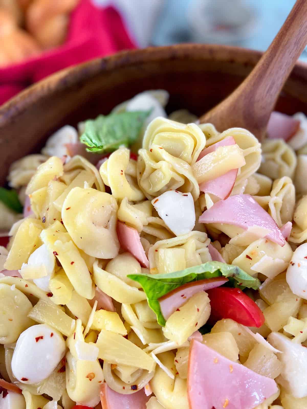 Close up image of Hawaiian pasta salad on serving spoon.