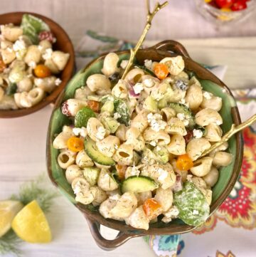 Mediterranean pasta salad in decorative serving bowl.
