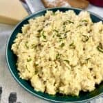 Mushroom risotto in green bowl.