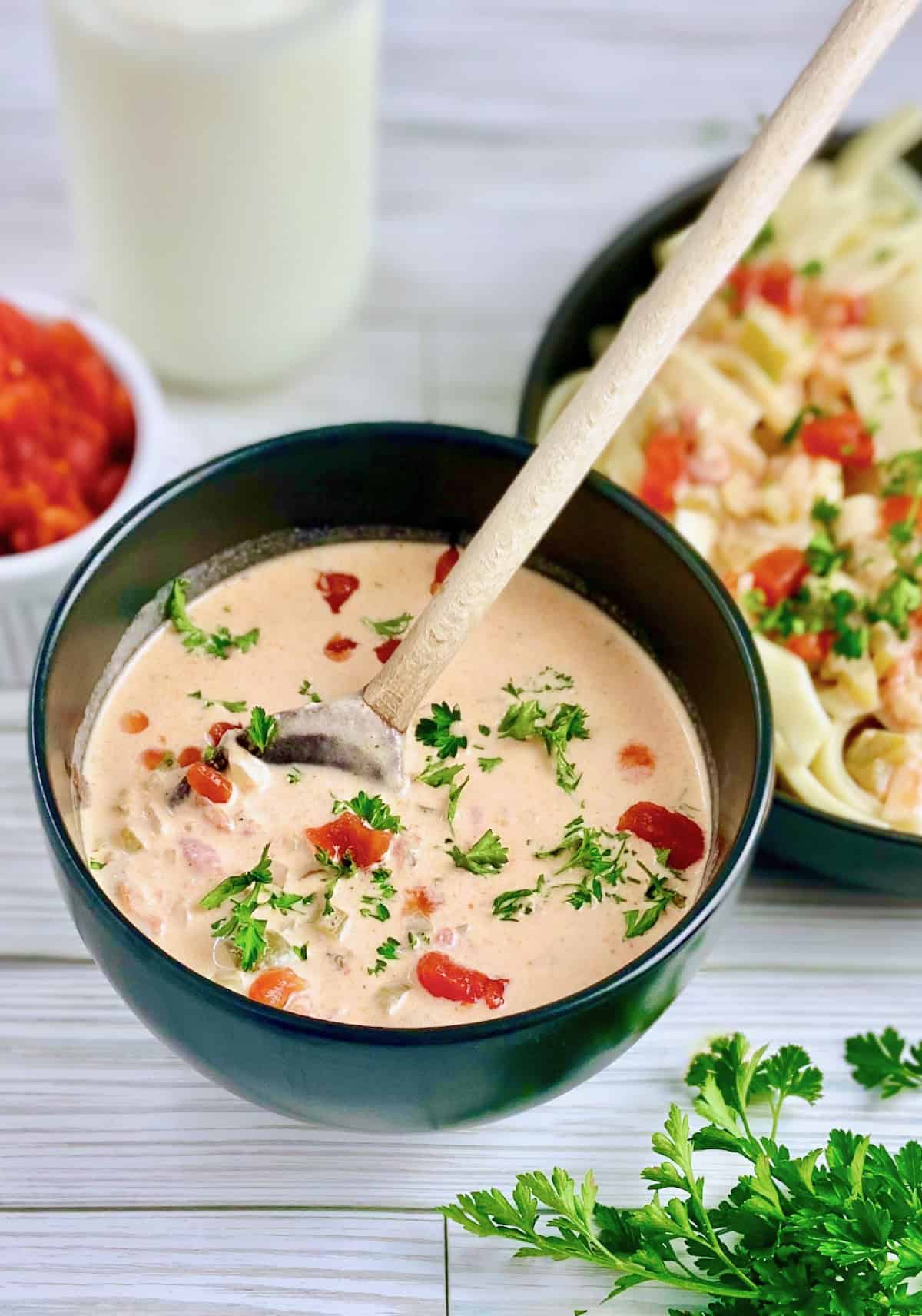 Creole cream sauce in black serving bowl garnished with chopped parsley.
