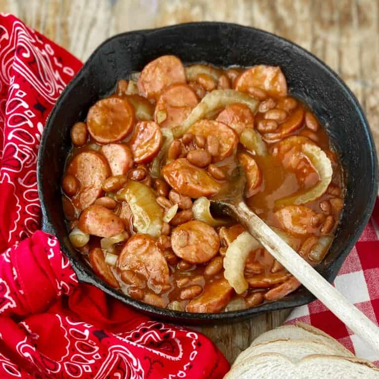 Skillet supper in cast iron skillet with wooden spoon.