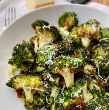 Roasted broccoli in white bowl.