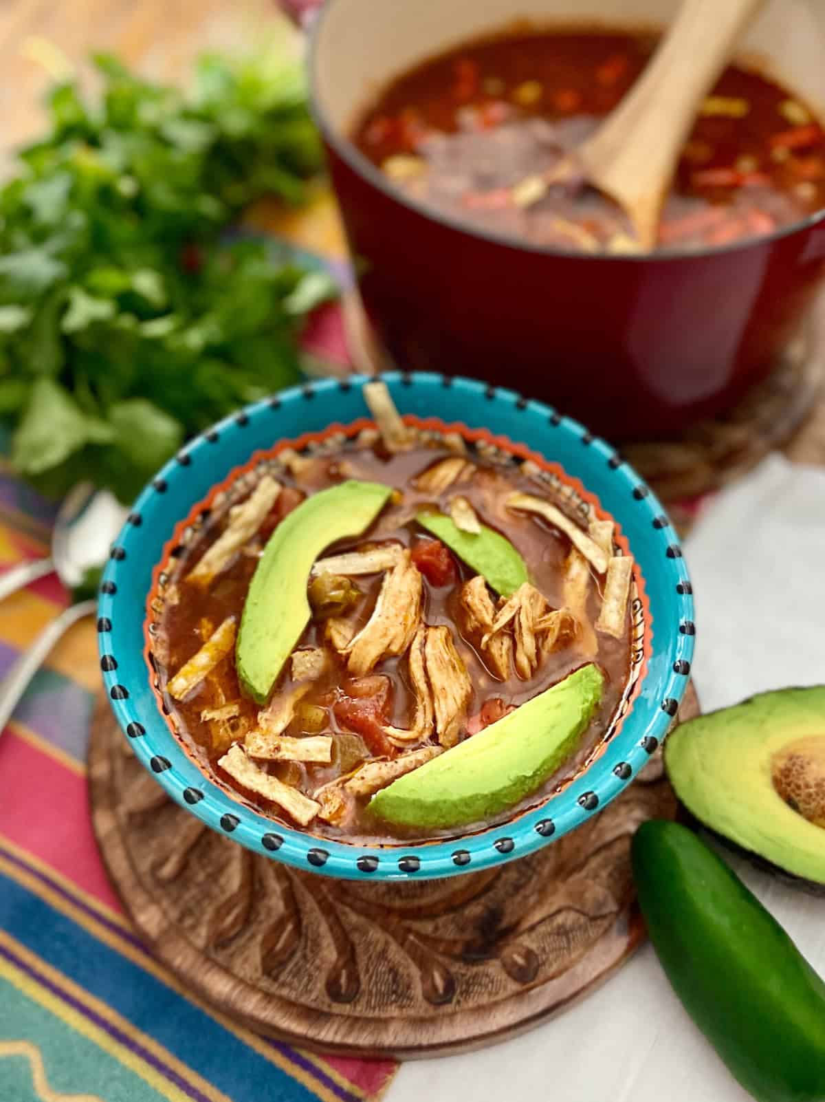 Bowl of chicken tortilla soup in decorative bowl.