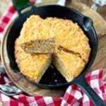 Beer cheese bread sliced in cast iron skillet.