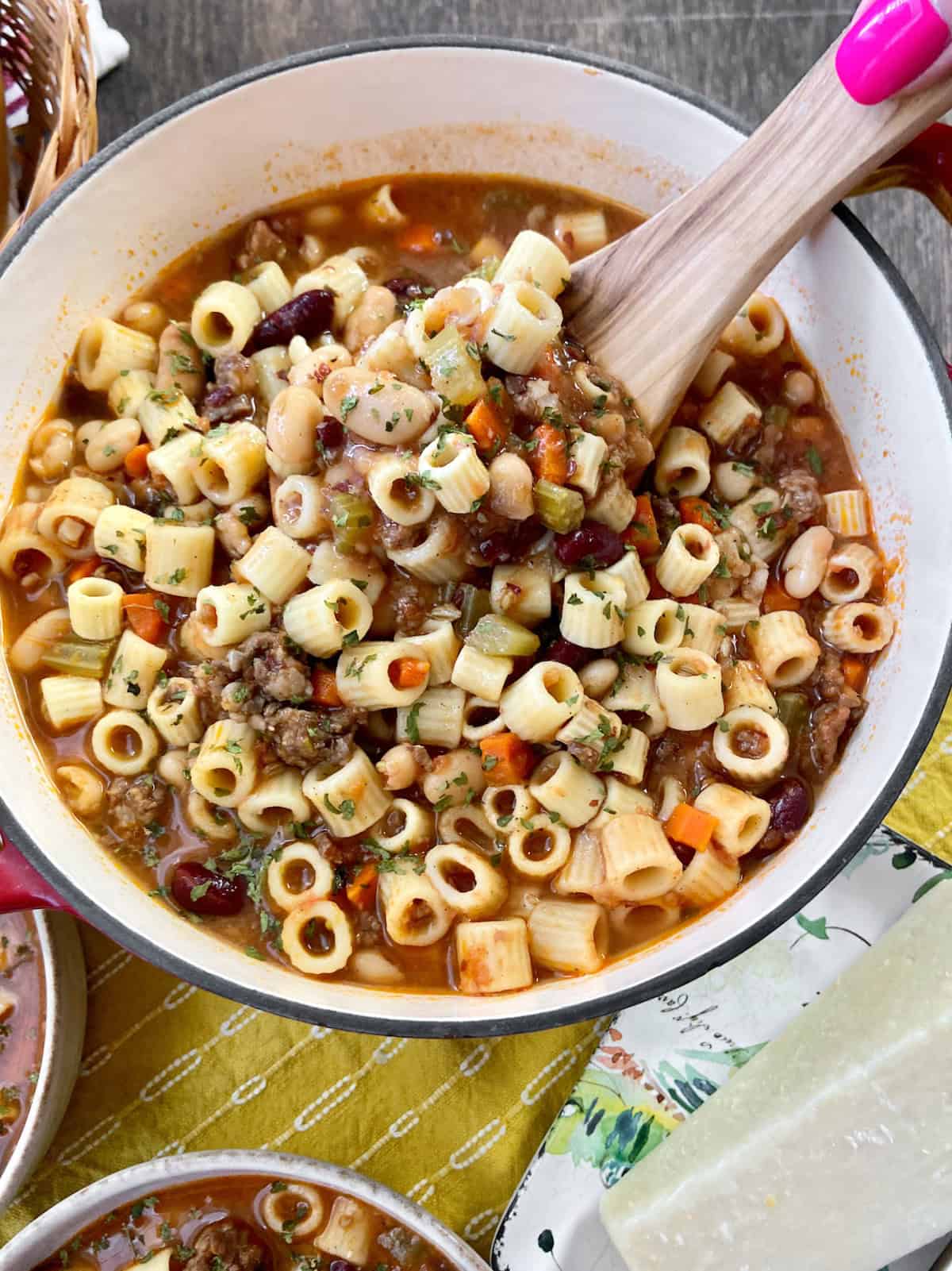 Pasta Fagioli in Dutch oven with wooden ladle.