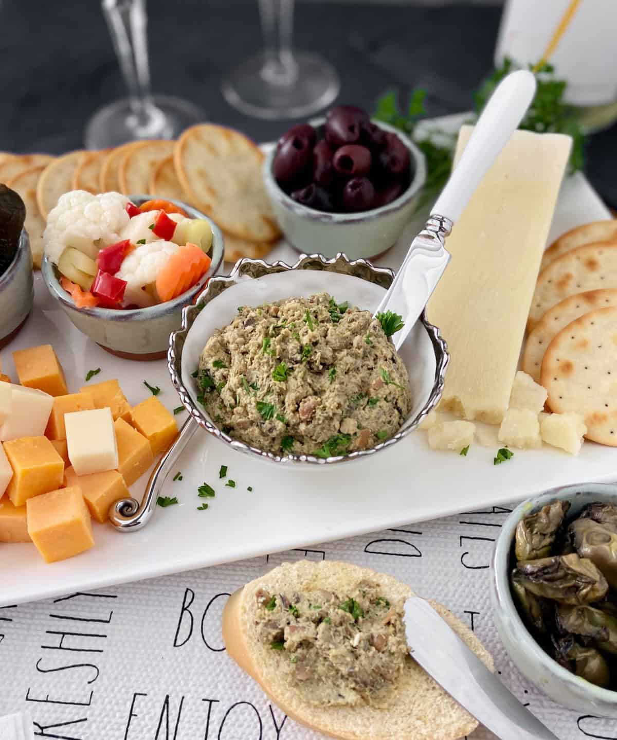 Bowl of smoked oyster pate on charcuterie board.