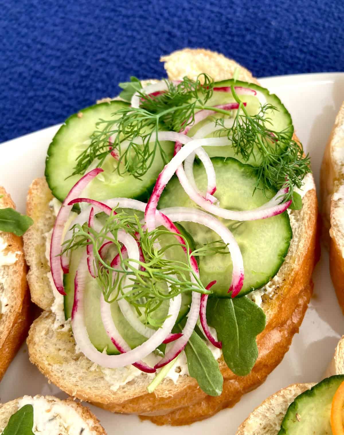 Spiraled radishes, cucumber, and fresh dill on bread.