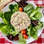 Tuna salad on a bed of mixed greens with grape tomatoes.