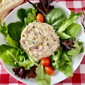 Tuna salad on a bed of mixed greens with grape tomatoes.