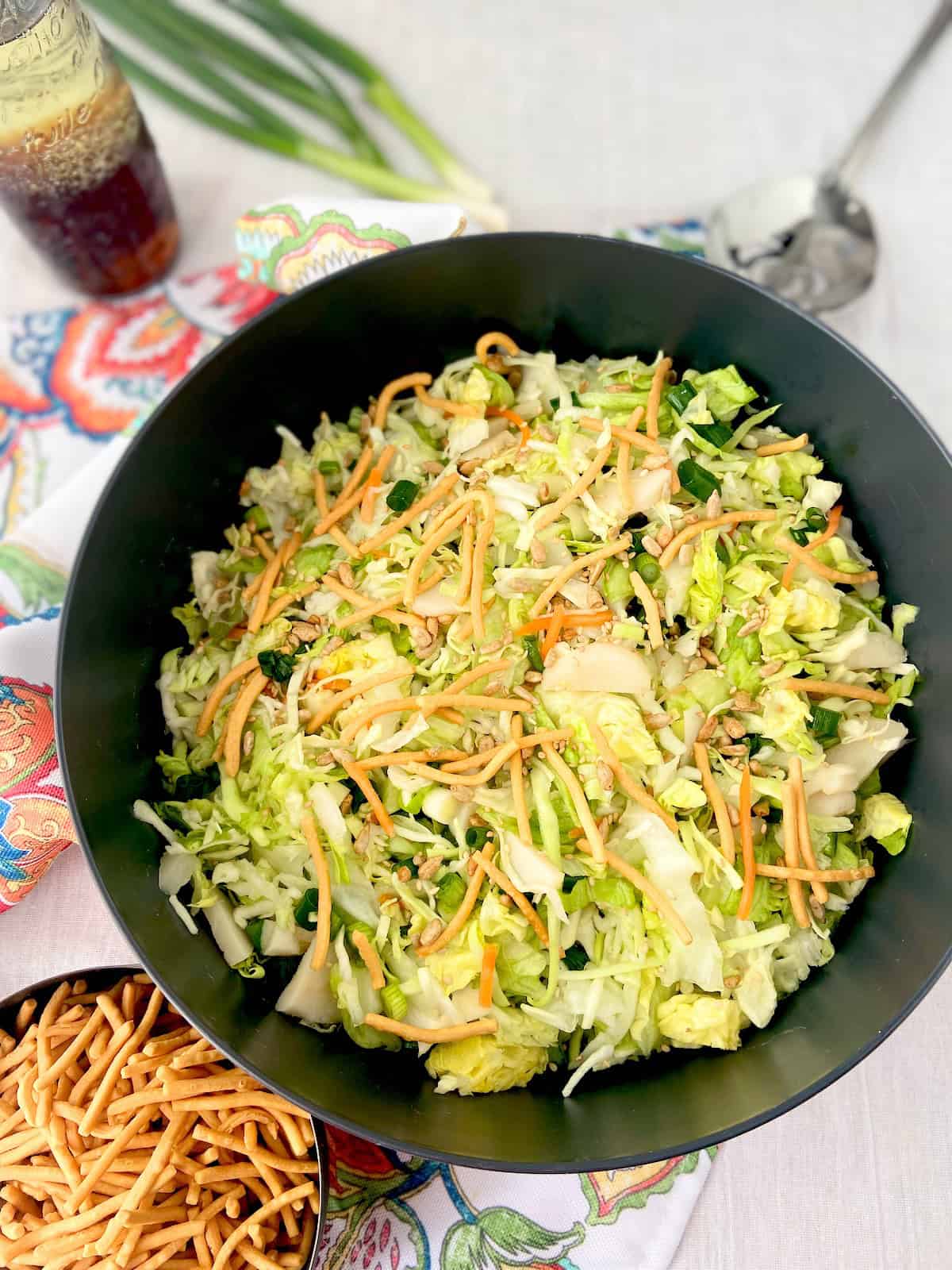Asian chopped salad in black serving bowl.