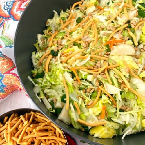 Asian chopped salad in black bowl.