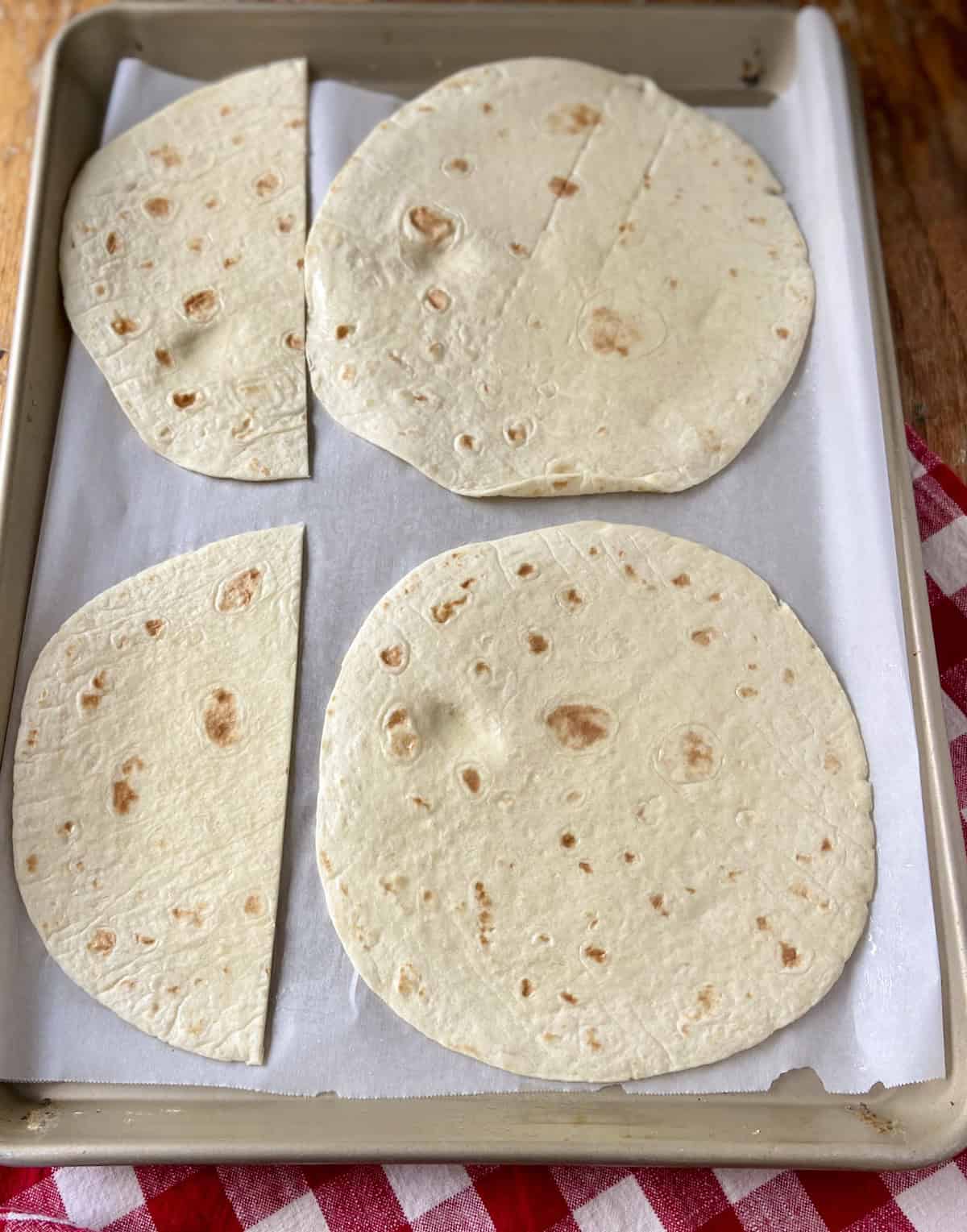 Flour tortillas on baking sheet.