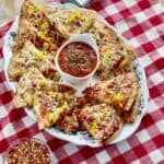 Italian nachos on serving platter with bowl of marinara.