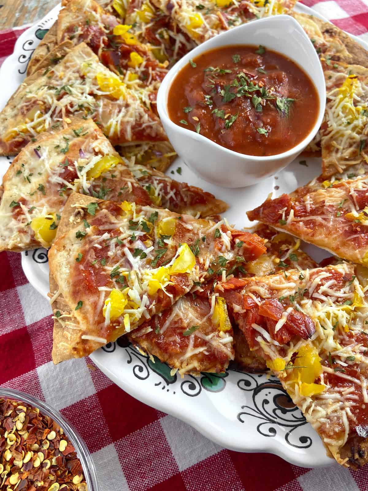 Italian nachos on decorative serving platter.