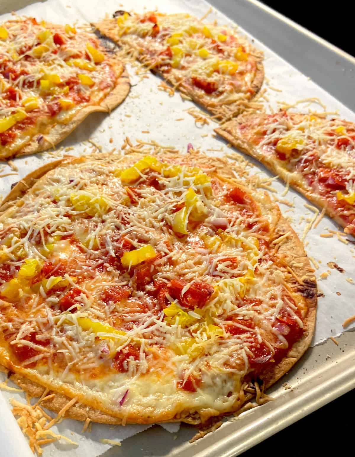 Italian nacho topped with shredded Parmesan cheese.
