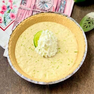 No Bake Key Lime Icebox pie on wooden table.