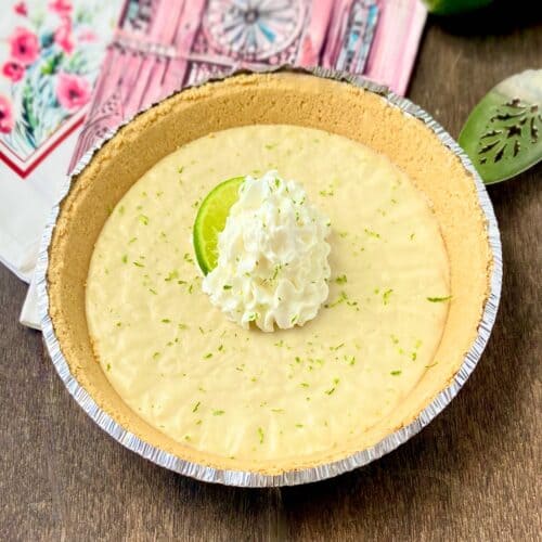 No Bake Key Lime Icebox pie on wooden table.