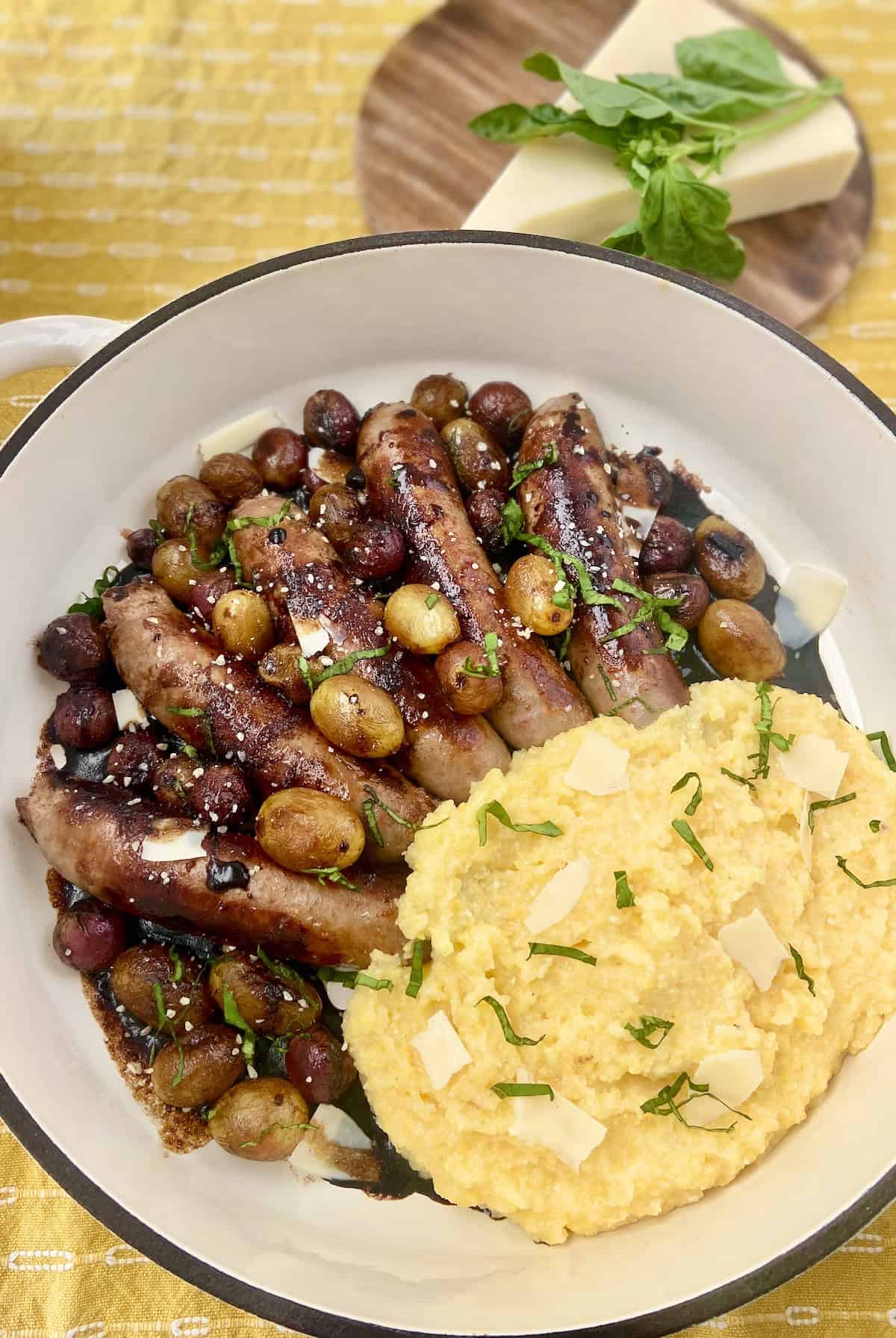 Italian sausage links with grapes and balsamic vinegar and a side of polenta.