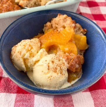 Peach cobbler in blue bowl.