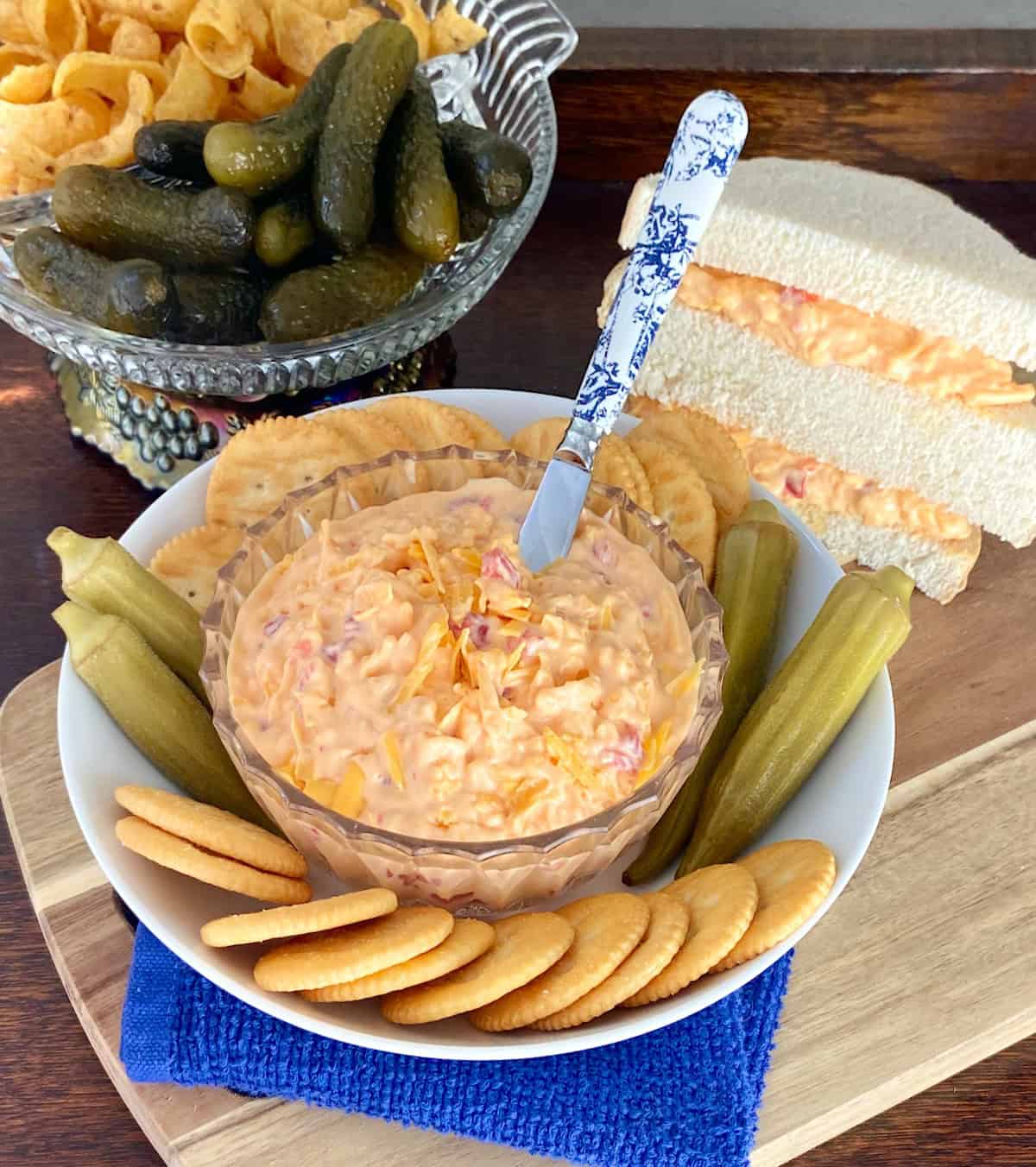 Pimento cheese in crystal bowl with Ritz crackers around the bowl.