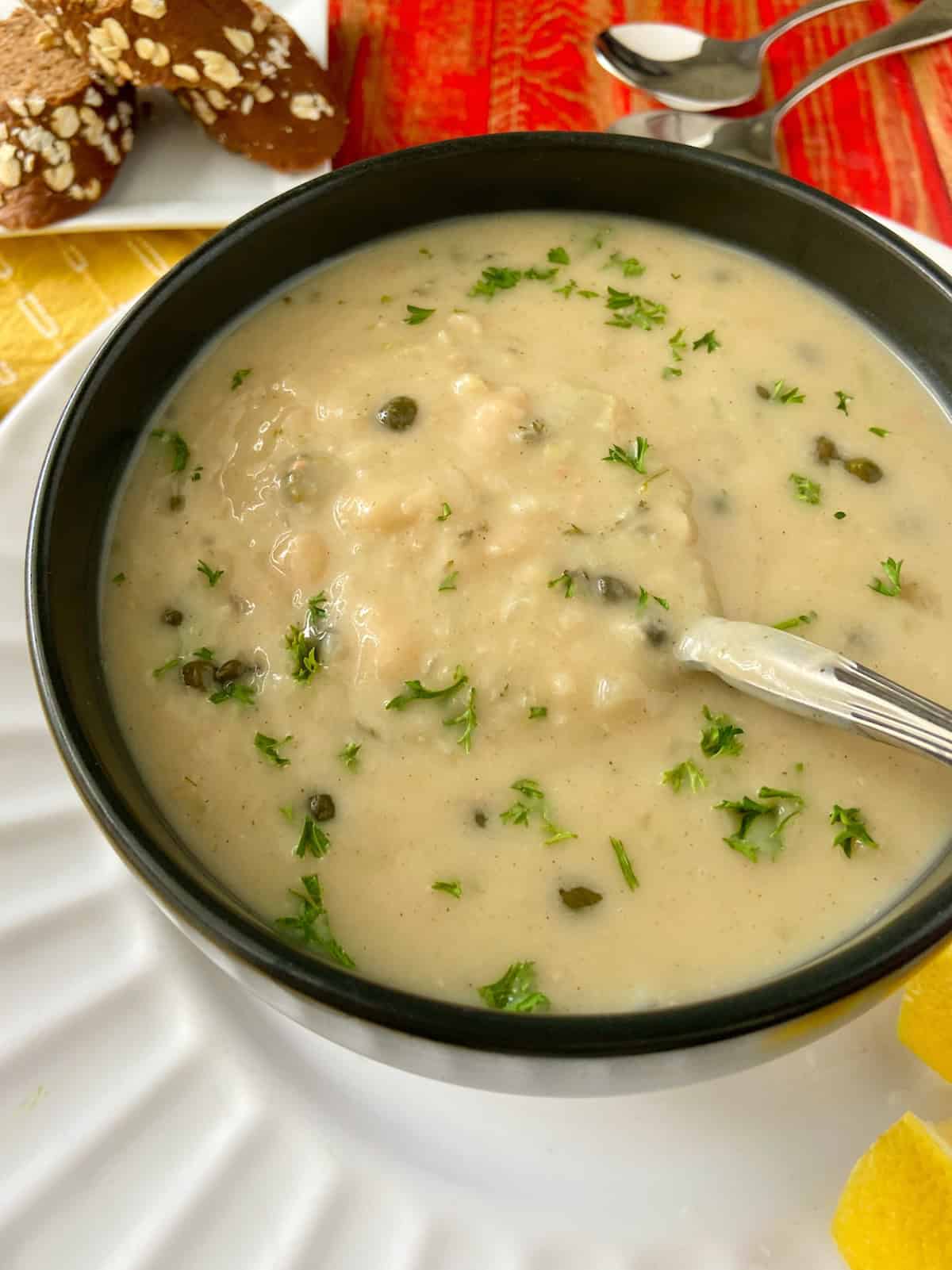 Close up image of white bean soup garnished with fresh parsley.