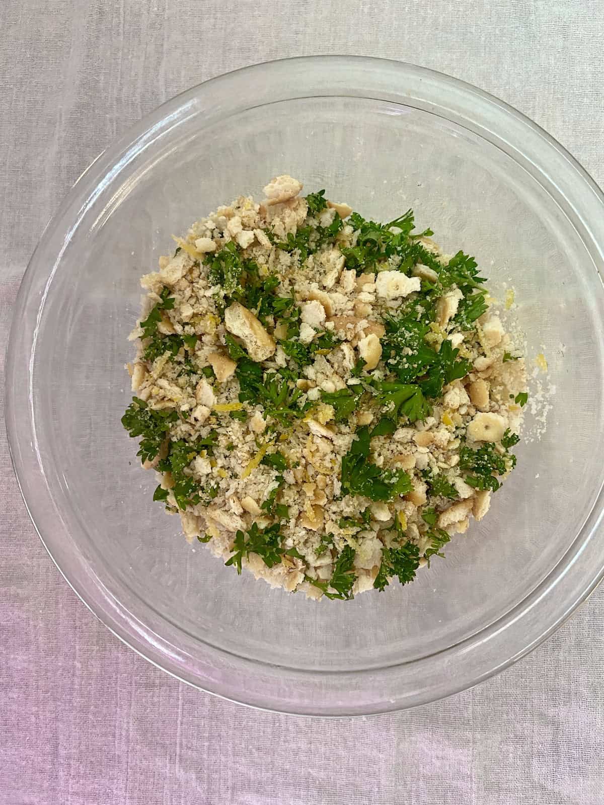 Breadcrumbs and parsley in mixing bowl.