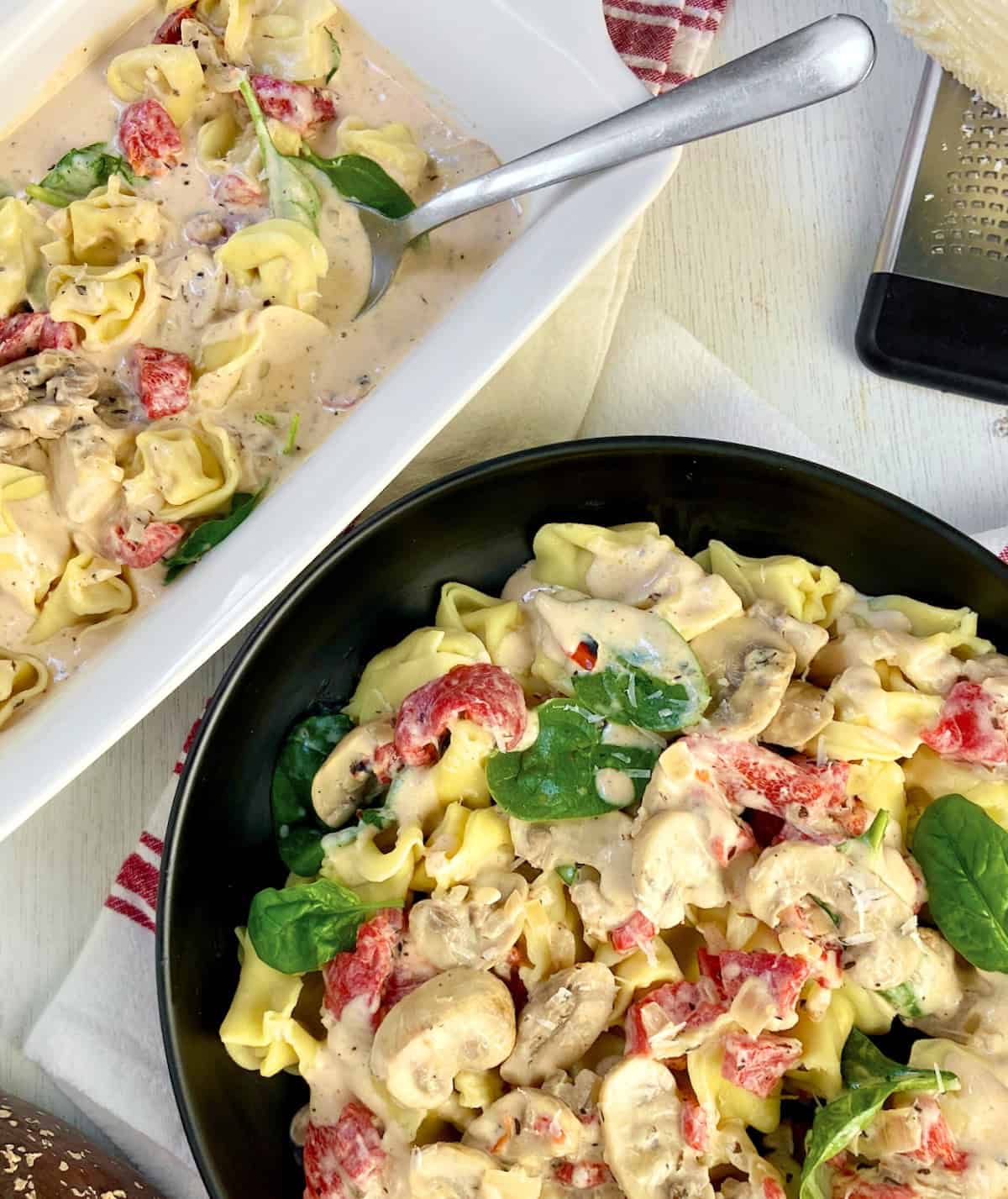 Tuscan cream sauce over tortellini with mushrooms, spinach and red peppers.